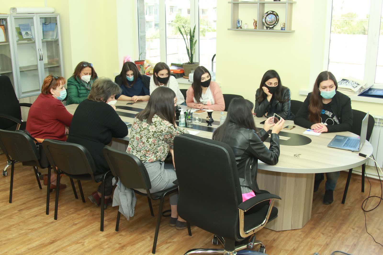 People around table during webinars