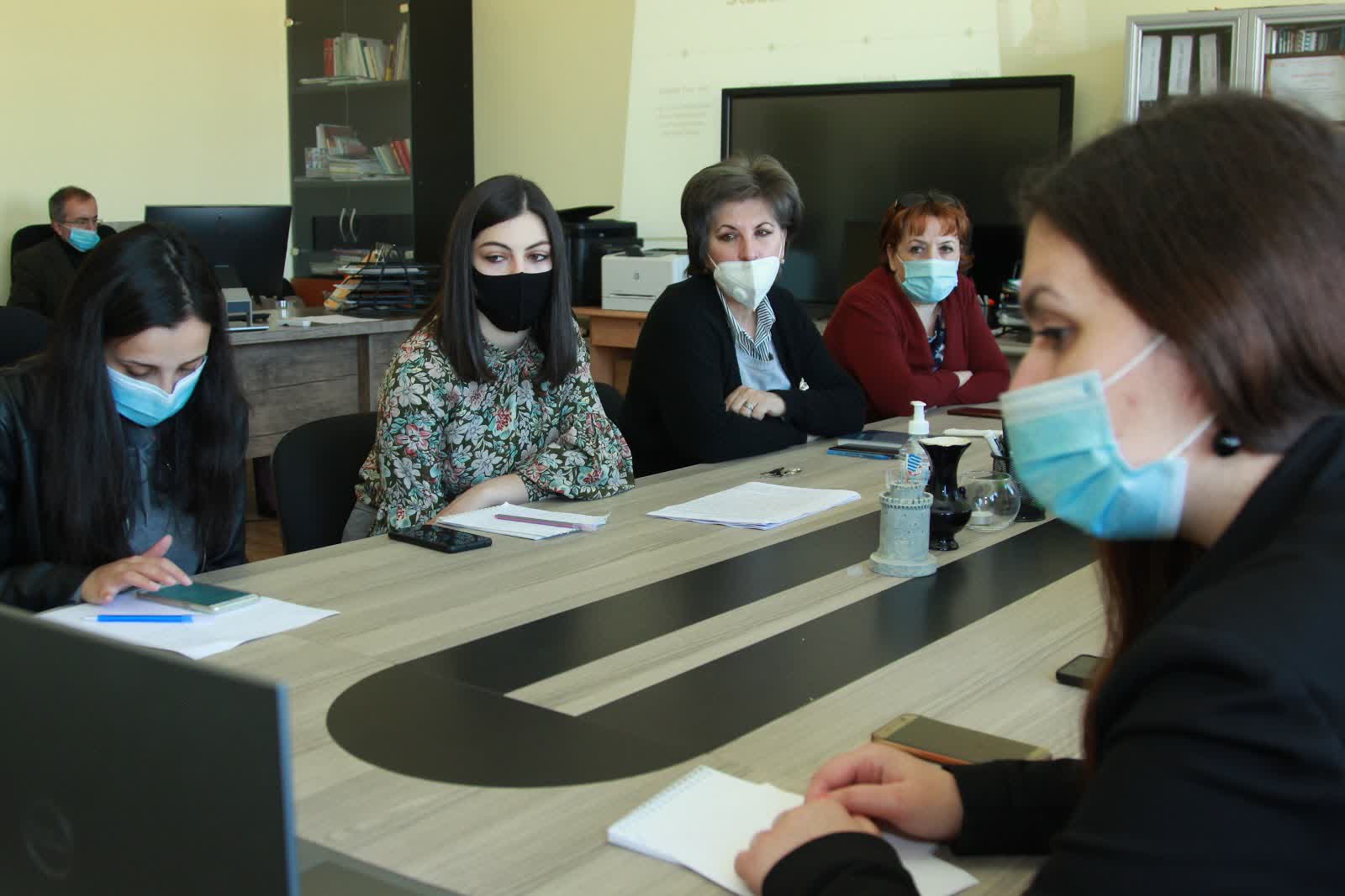 People around table during webinars